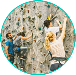 Parent and child climbing an indoor rock wall together