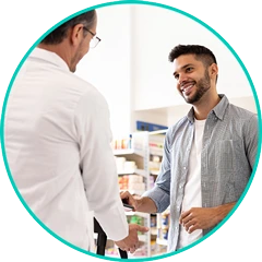 Pharmacist helping a patient pick up a RELEXXII prescription at the pharmacy counter